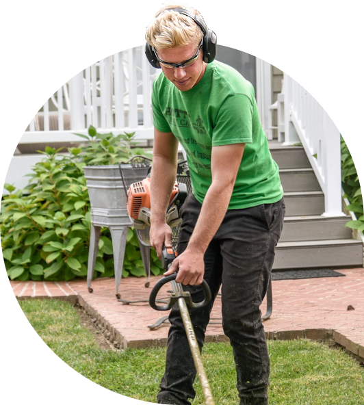 Landscaper trimming a client's yard